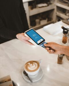 Customer paying with a credit card at a point of sale terminal showing how surcharging works in 2026