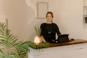 a woman sitting at a desk with a laptop