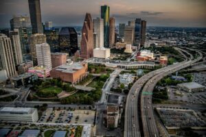 The modern skyline of Houston, Texas at dusk on a mid summer evening shot via helicopter from an altitude of a