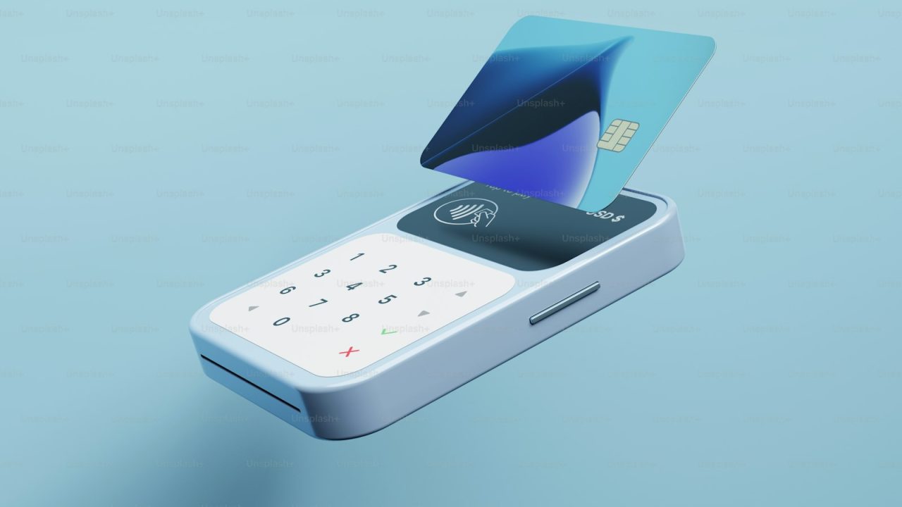 a cell phone with a credit card sticking out of it