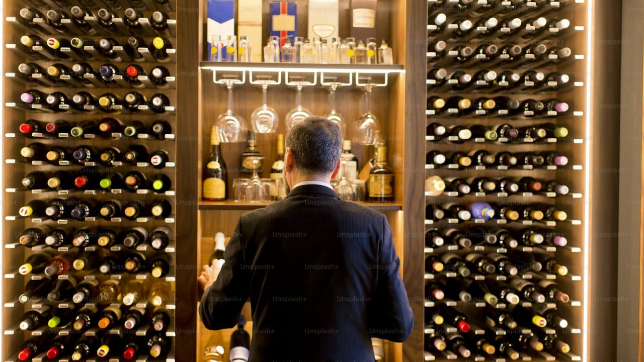 Middle-aged handsome man chooses a bottle of wine