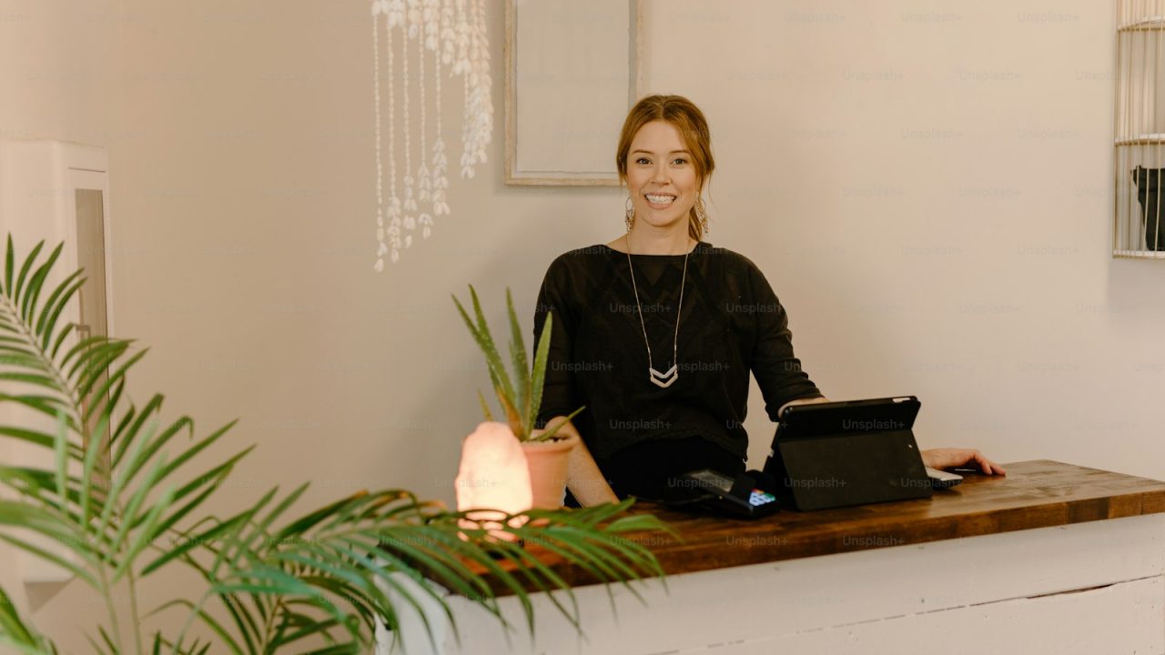 a woman sitting at a desk with a laptop