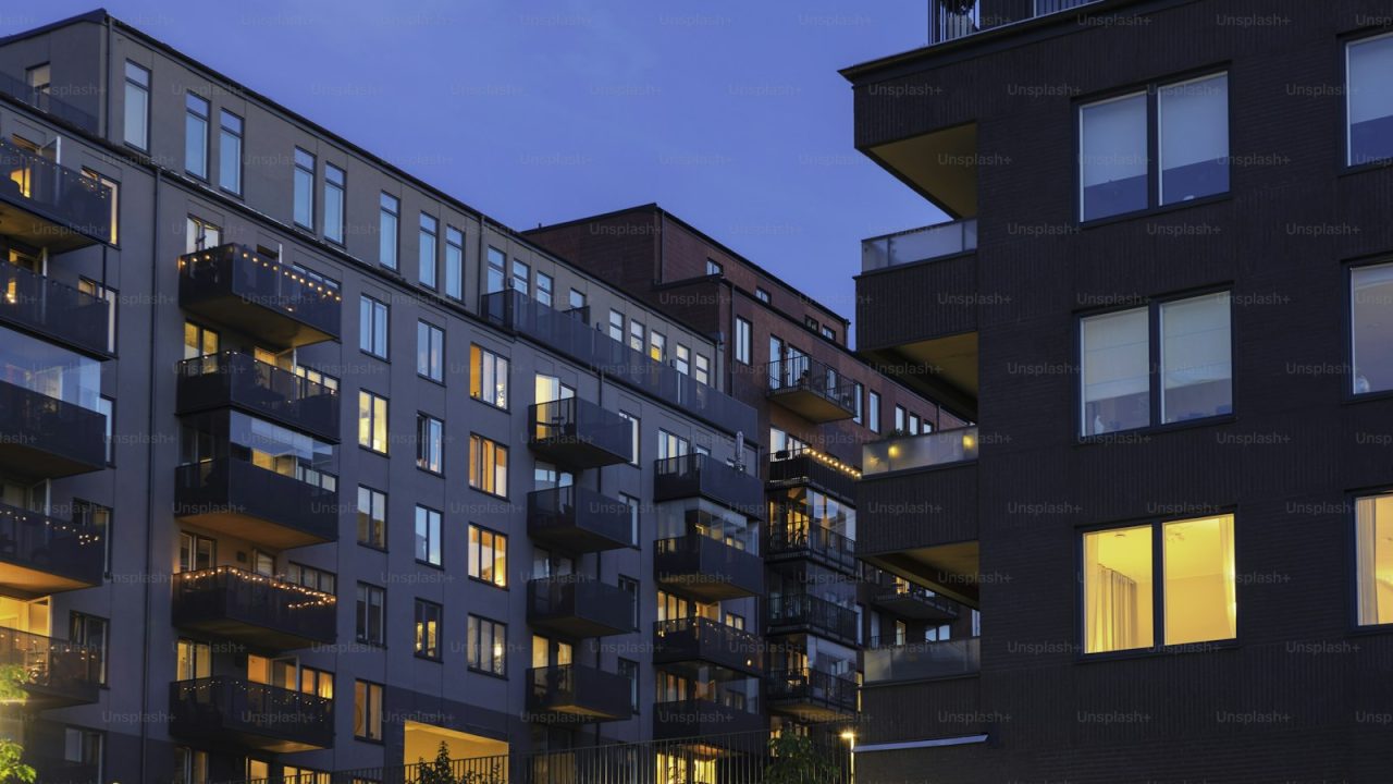 A street with modern apartment buildings at night in Hammarby Sjöstad, Stockholm, Sweden.