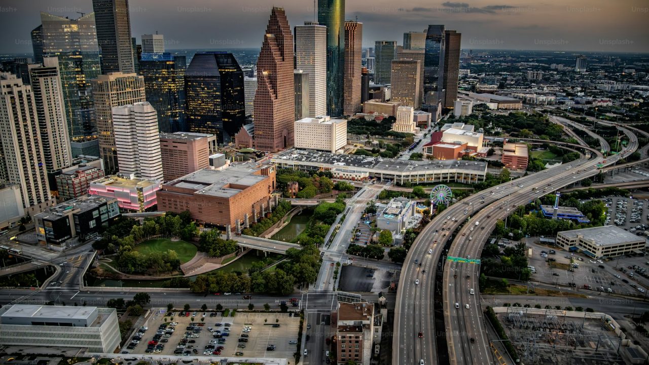 The modern skyline of Houston, Texas at dusk on a mid summer evening shot via helicopter from an altitude of a